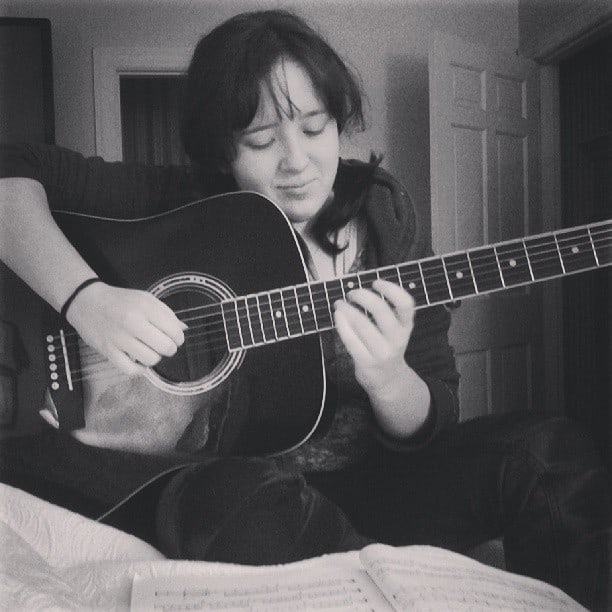 Emily with her guitar.